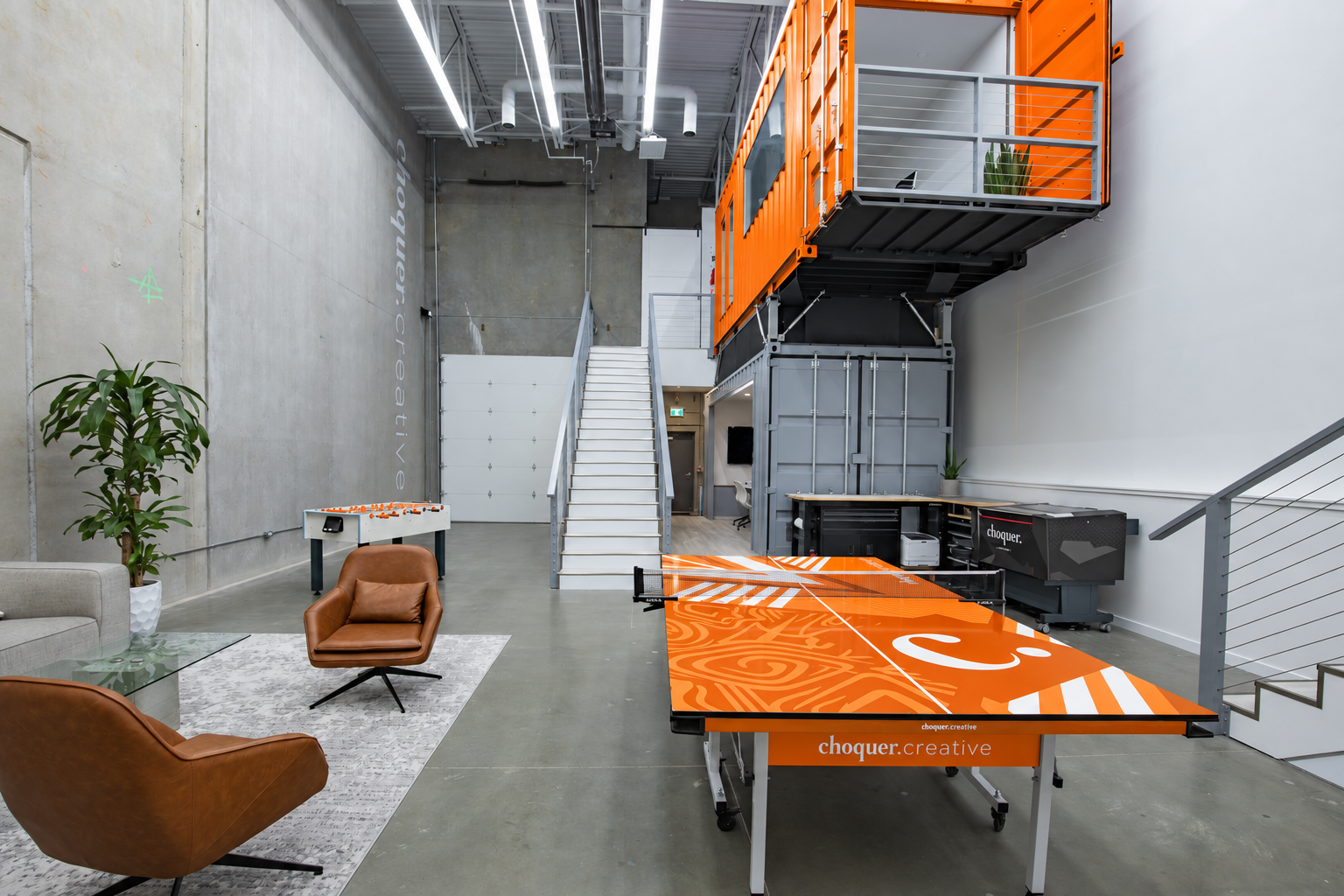 Choquer Agency office with its orange meeting space and ping pong table